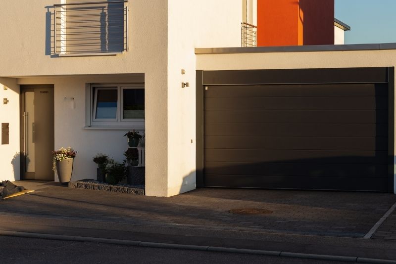 Modern home with an enclosed double carport built into the facade