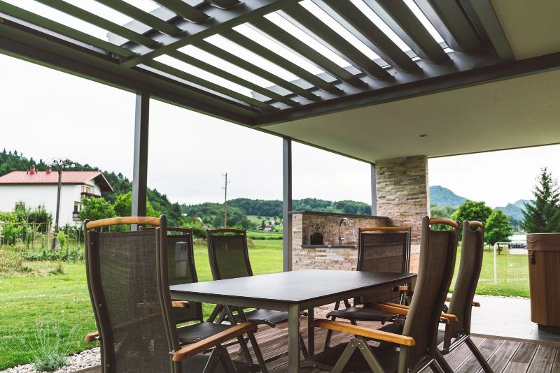 pergola attached to the house with a dining table and six chairs