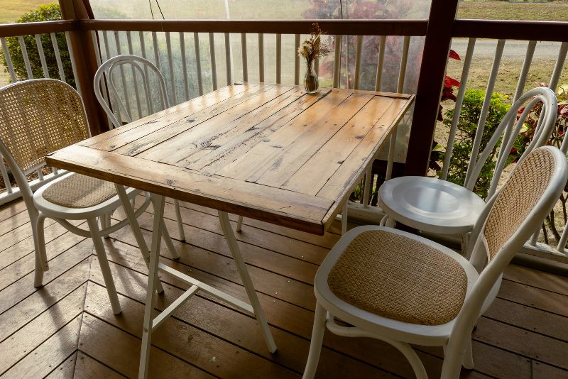 timber verandah with a table and four chairs